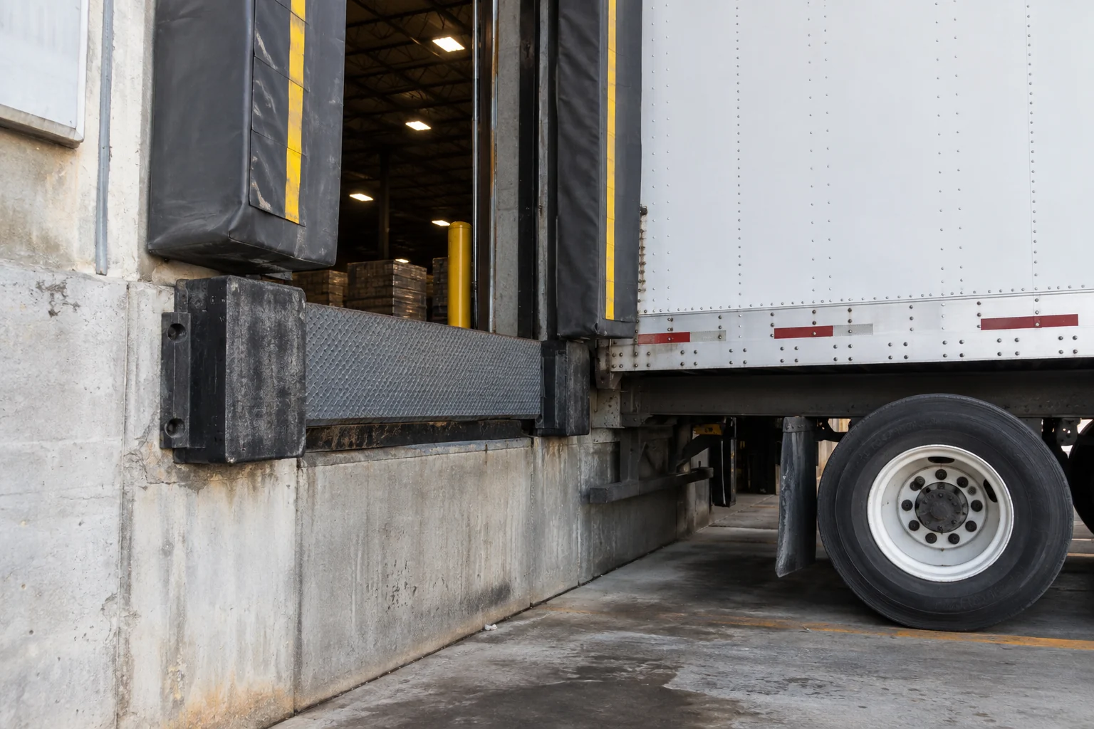 An angled view of a loading dock and trailer, a representative warehouse handoff scene